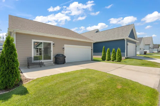 a view of a house with backyard and a tree