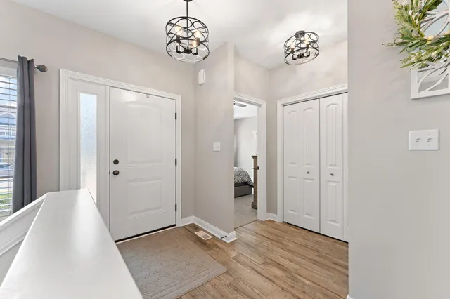 a view of a hallway with a chandelier fan