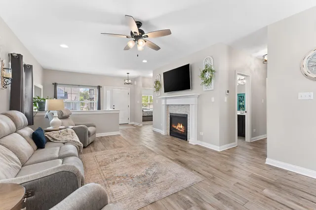 a living room with furniture a fireplace and a flat screen tv