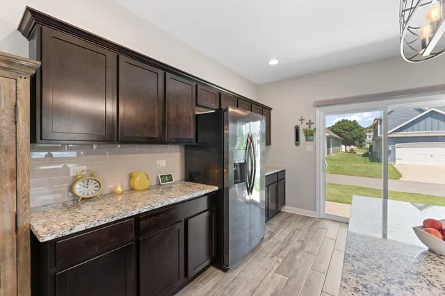 a kitchen with a refrigerator and a sink