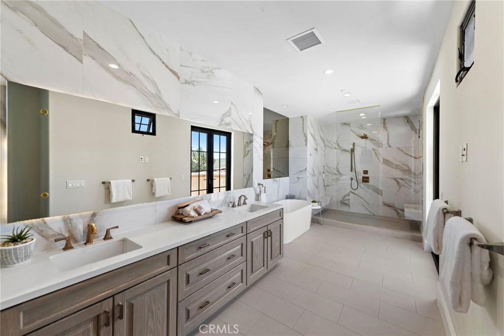 19 Alexa Lane Ladera Ranch, CA 92694 - Photo 28 of 63 a bathroom with a double vanity sink a mirror and a shower
