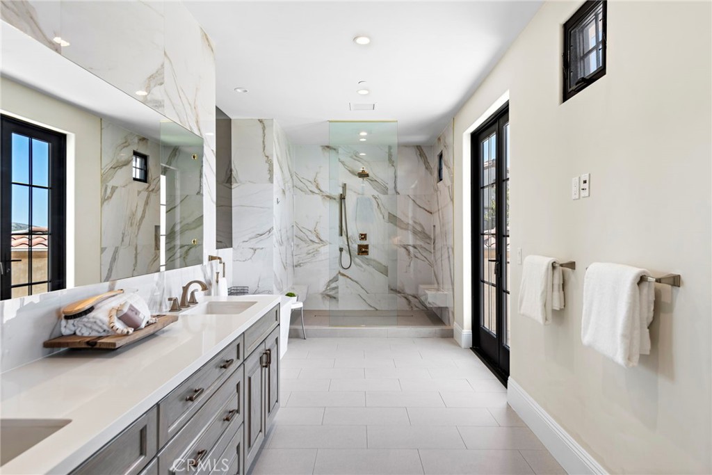 19 Alexa Lane Ladera Ranch, CA 92694 - Photo 31 of 63 a bathroom with a double vanity sink a mirror and shower