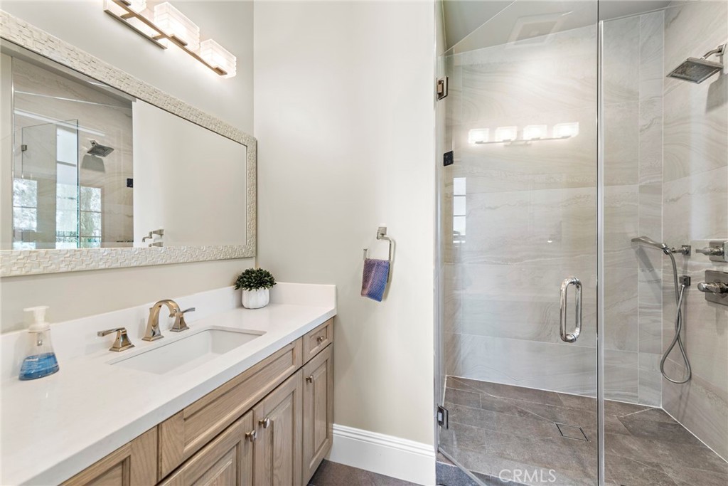 19 Alexa Lane Ladera Ranch, CA 92694 - Photo 36 of 63 a bathroom with a sink vanity granite shower and a mirror