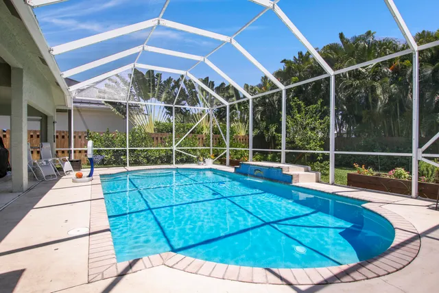 a front view of a house with a garden and yard