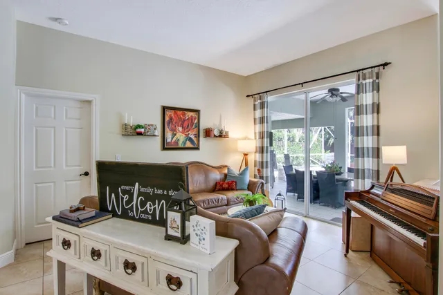 a living room with furniture chandelier and a flat screen tv