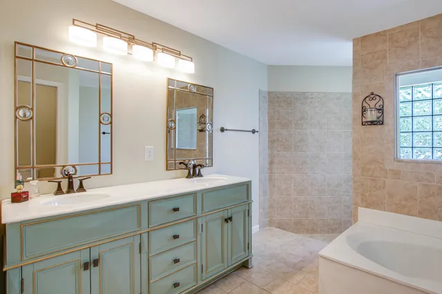 a bathroom with a window and a shower
