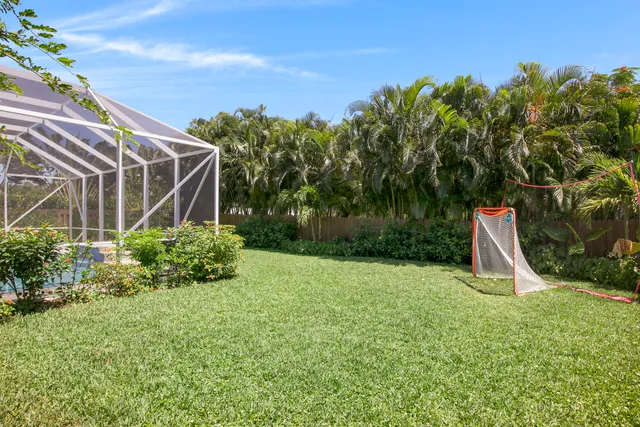 a view of a backyard with plants and a patio