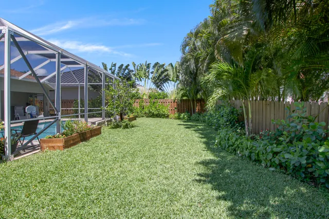 a view of a house with backyard sitting area and garden