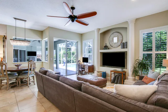 a kitchen with stainless steel appliances granite countertop a refrigerator a sink a stove and island