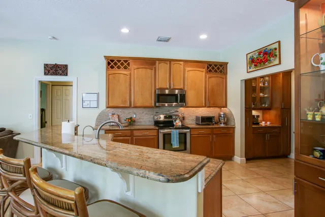 a kitchen with stainless steel appliances a stove sink and cabinets