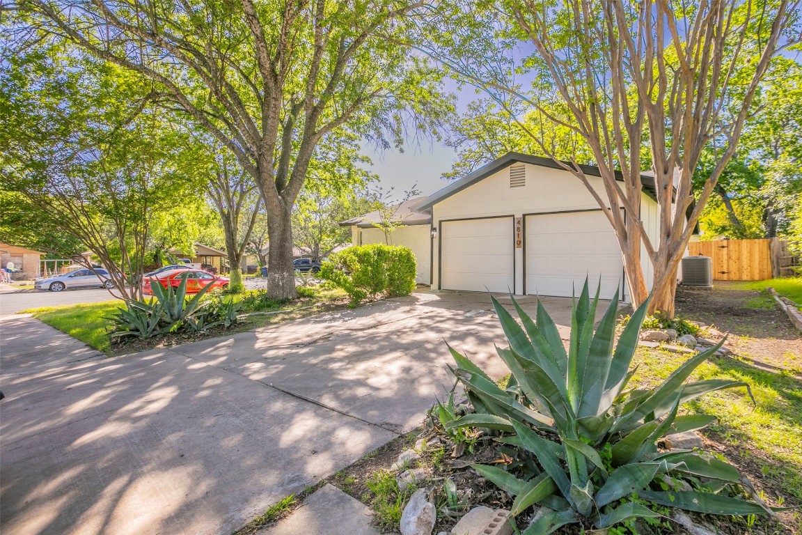 4810 Peach Grove Court Austin, TX 78744 - Photo 1 of 1 a front view of a house with garden