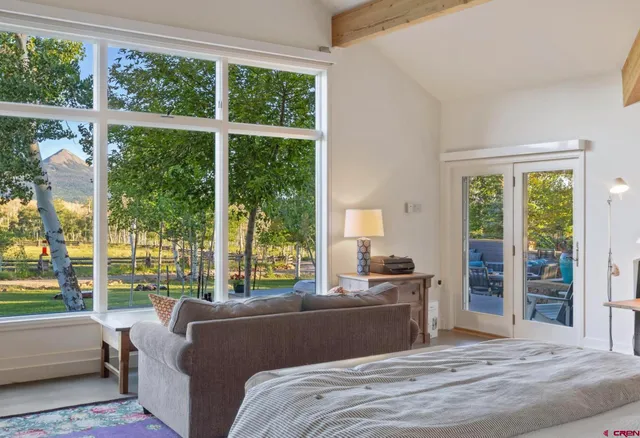 a bedroom with a bed and a large window