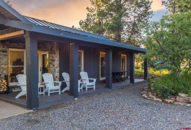 a view of a house with backyard porch and garden