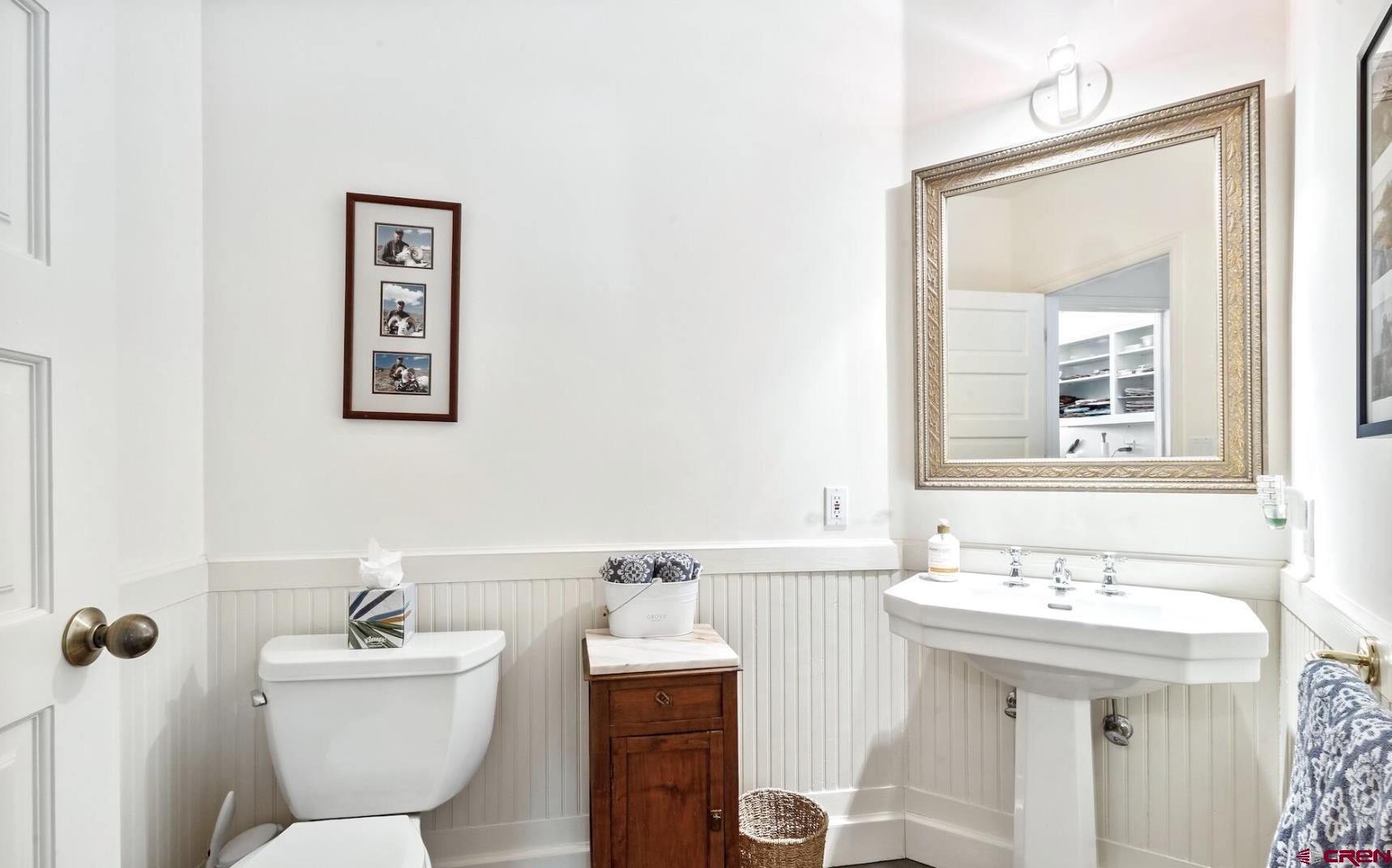3289 Laughing Dog Road Placerville, CO 81430 - Photo 24 of 35 a bathroom with a toilet a sink and mirror