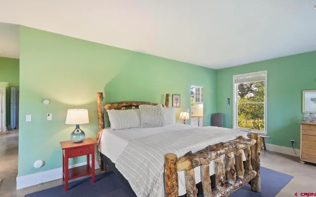 a bedroom with a bed and window