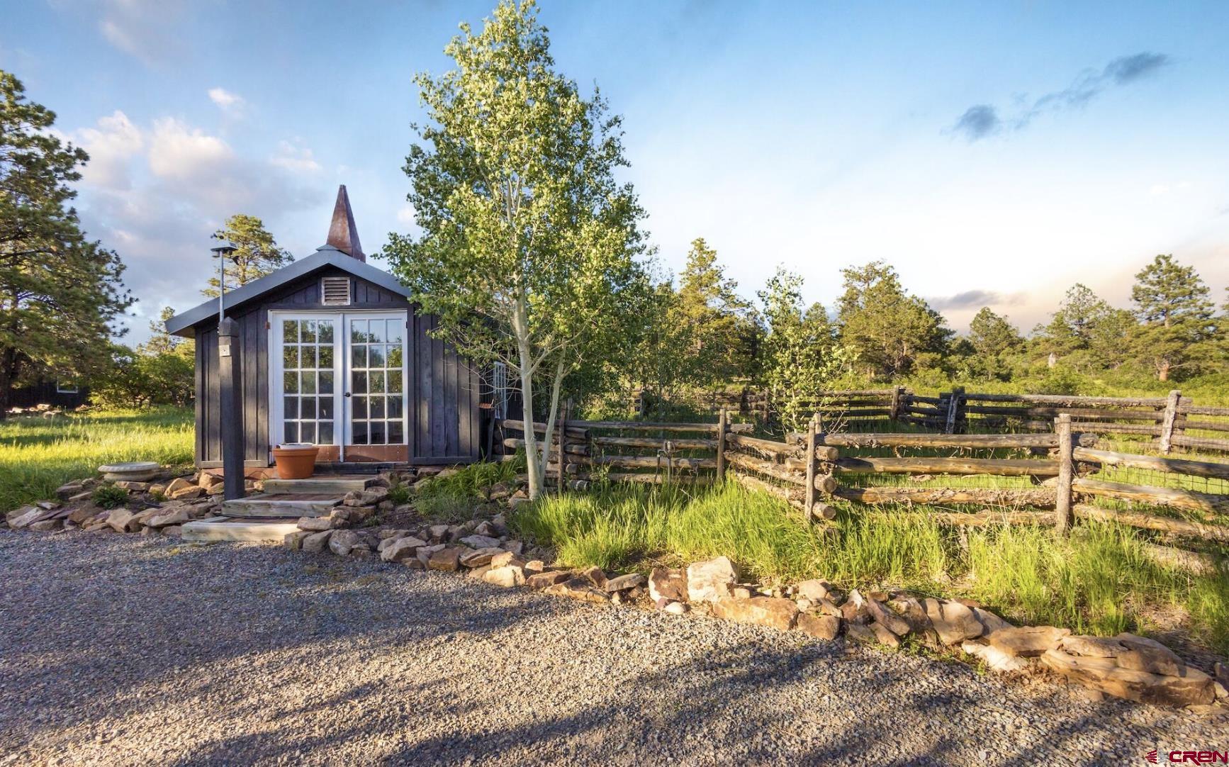 3289 Laughing Dog Road Placerville, CO 81430 - Photo 28 of 35 a view of a house with swimming pool and sitting area