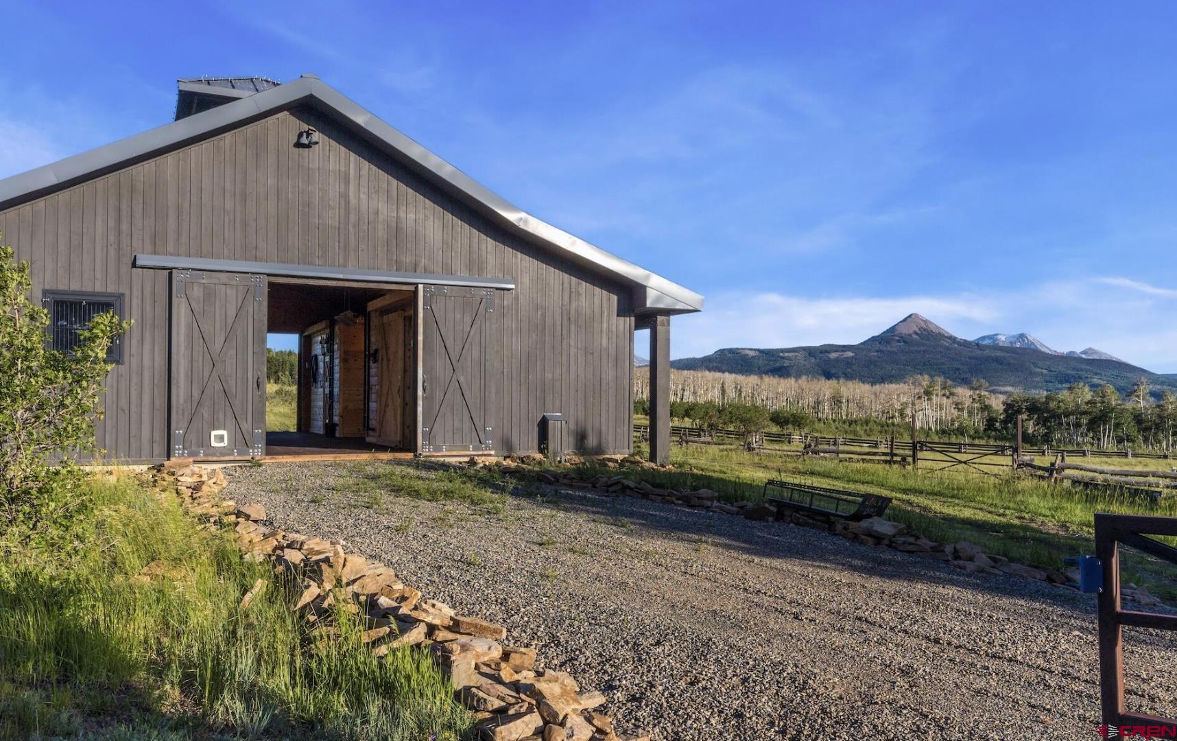 3289 Laughing Dog Road Placerville, CO 81430 - Photo 29 of 35 a front view of a house with a yard