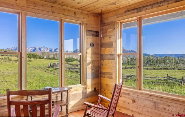 a view of a room with balcony and furniture