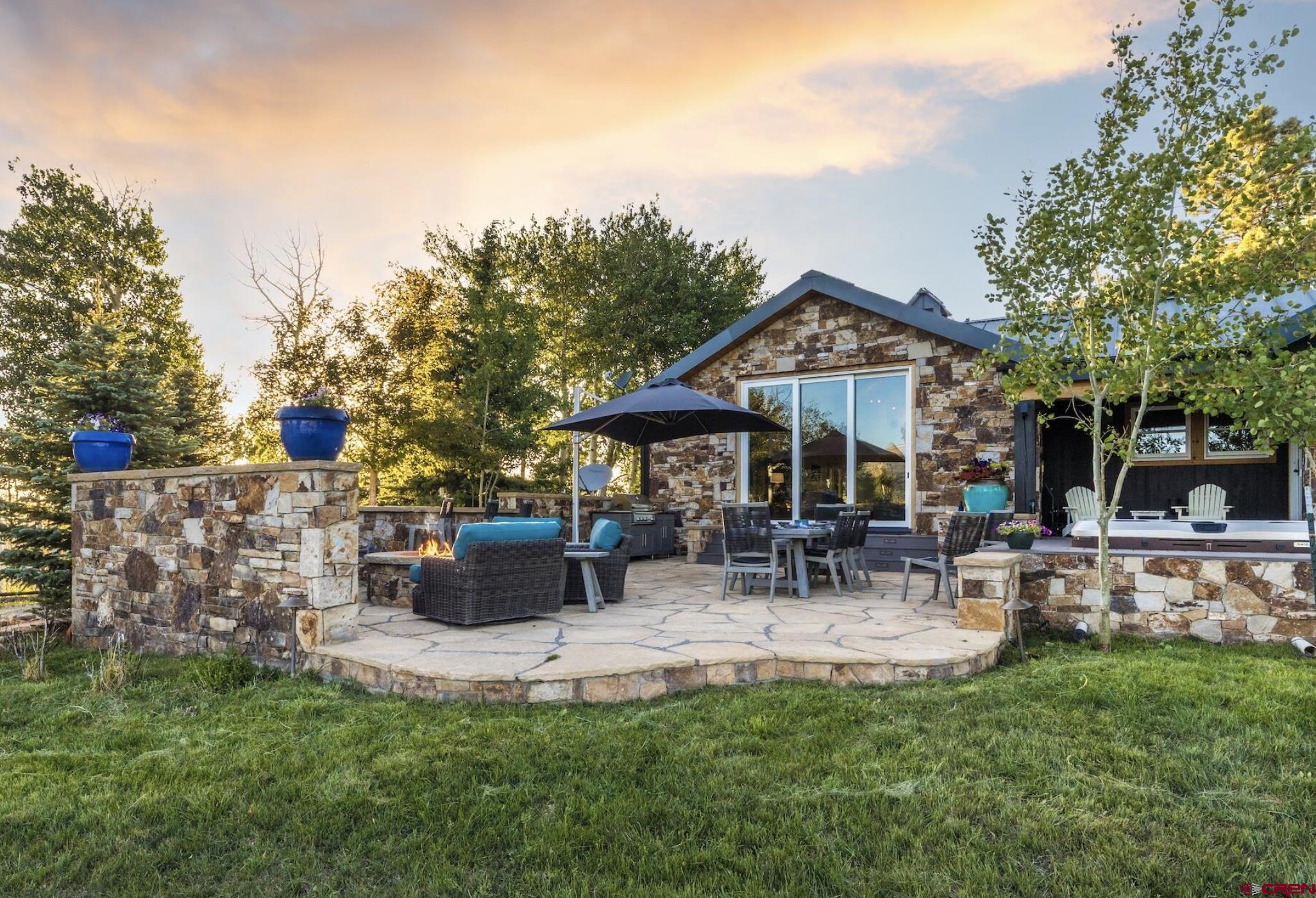 3289 Laughing Dog Road Placerville, CO 81430 - Photo 9 of 35 a view of patio with table and chairs under an umbrella