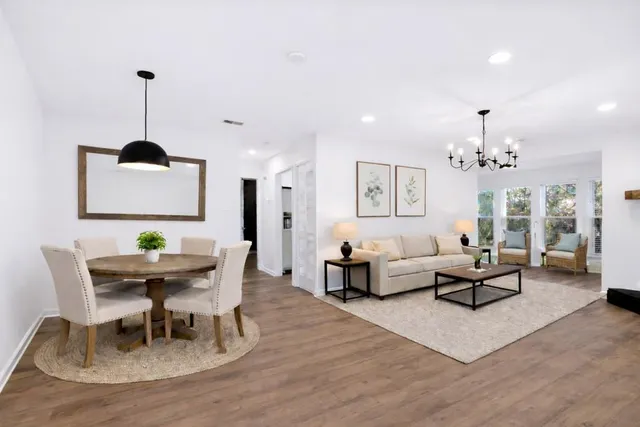 a living room with furniture and a chandelier