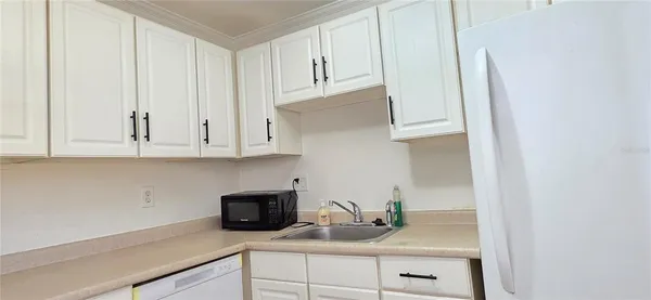 a kitchen with stainless steel appliances granite countertop white cabinets and a granite counter tops