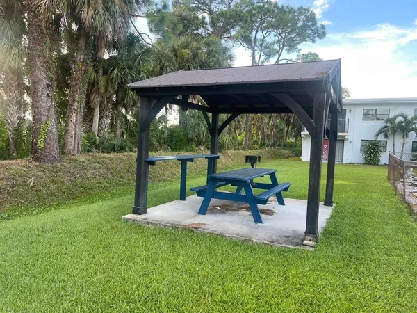 a view of a table and chairs in the garden