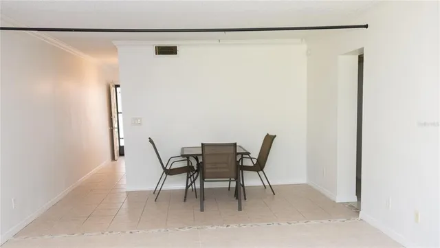 a dining room with furniture and a window