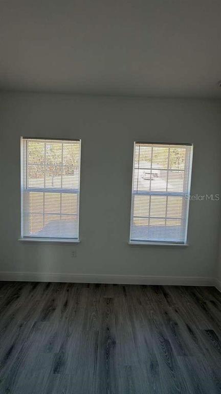 5669 North Claremont Drive Citrus Springs, FL 34434 - Photo 11 of 20 an empty room with wooden floor and windows