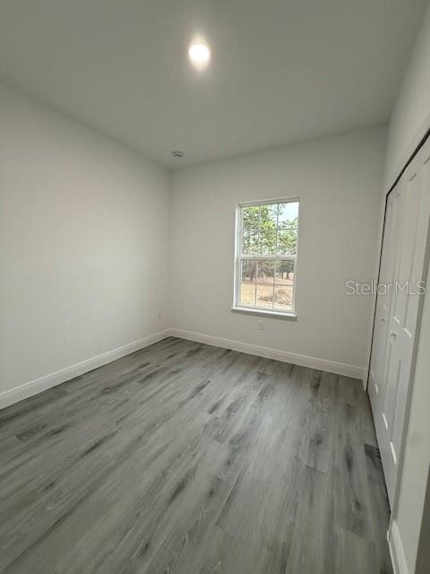 5669 North Claremont Drive Citrus Springs, FL 34434 - Photo 15 of 20 an empty room with wooden floor and windows