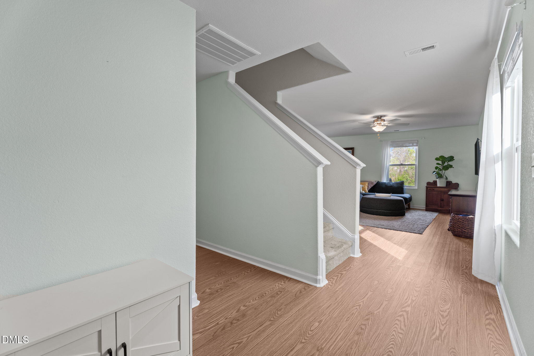 357 Gourd Street Zebulon, NC 27597 - Photo 12 of 50 a view of a livingroom with wooden floor and staircase