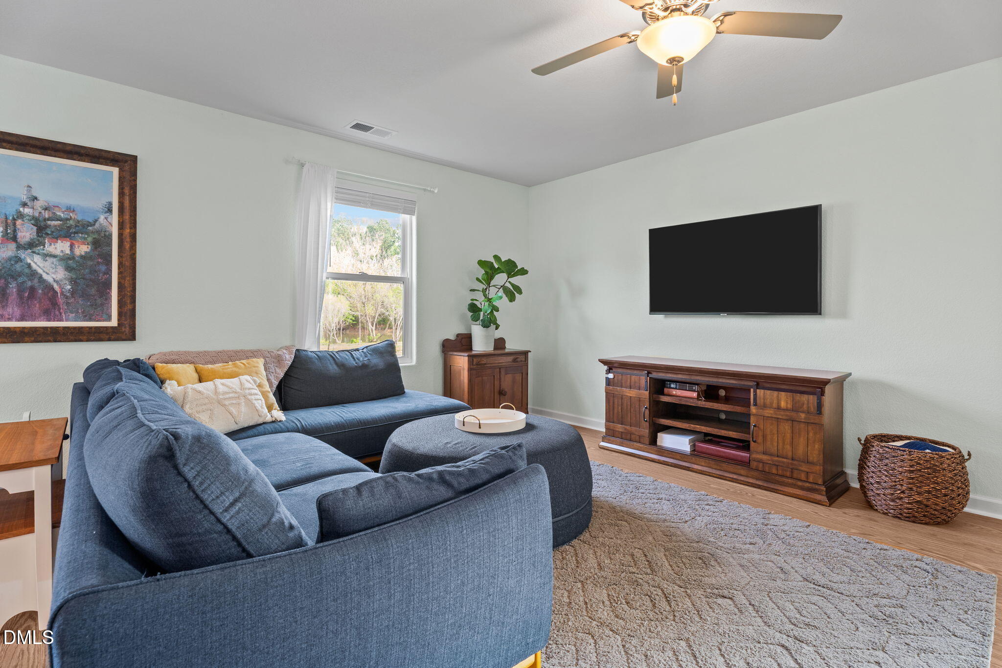 357 Gourd Street Zebulon, NC 27597 - Photo 15 of 50 a living room with furniture and a flat screen tv