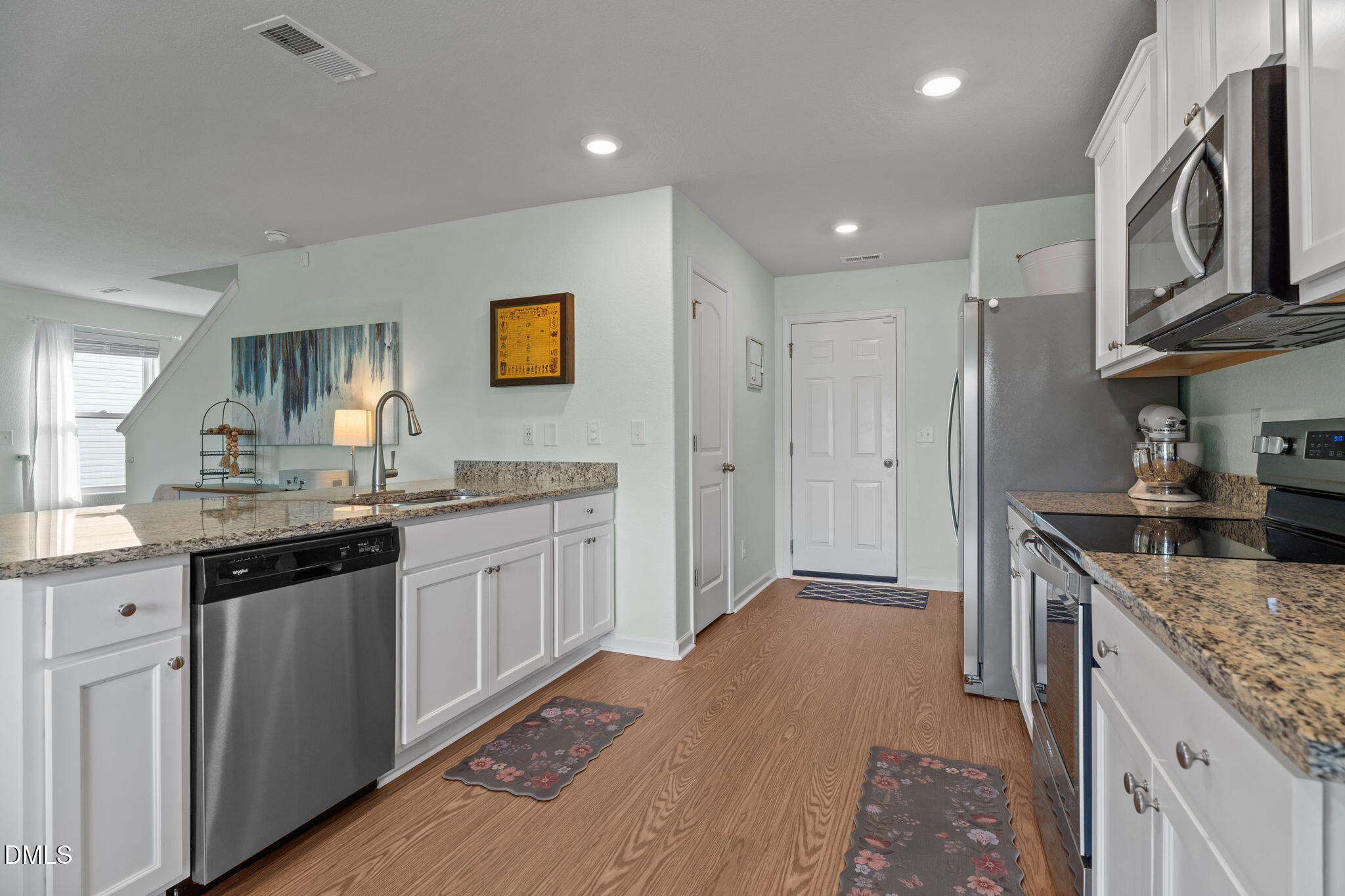 357 Gourd Street Zebulon, NC 27597 - Photo 19 of 50 a kitchen with stainless steel appliances granite countertop a sink stove and refrigerator