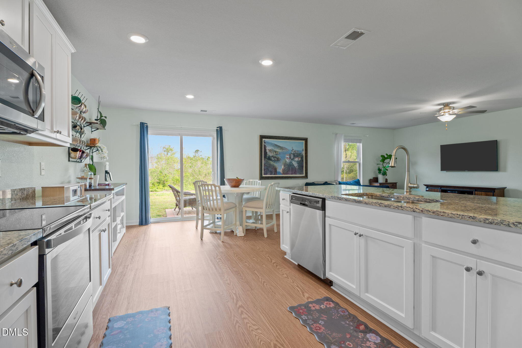 357 Gourd Street Zebulon, NC 27597 - Photo 21 of 50 a large white kitchen with lots of counter space a sink and appliances