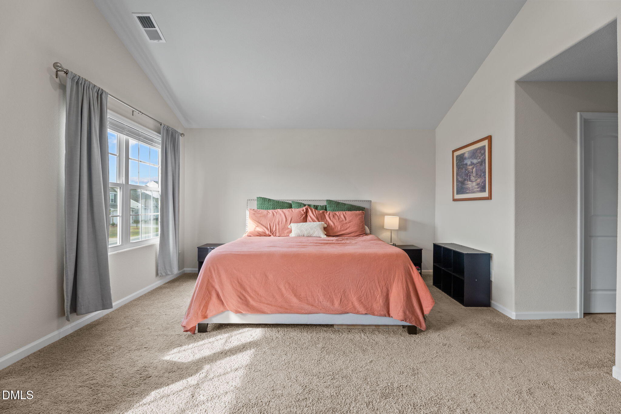 357 Gourd Street Zebulon, NC 27597 - Photo 24 of 50 a bedroom with a bed lamp and a large window