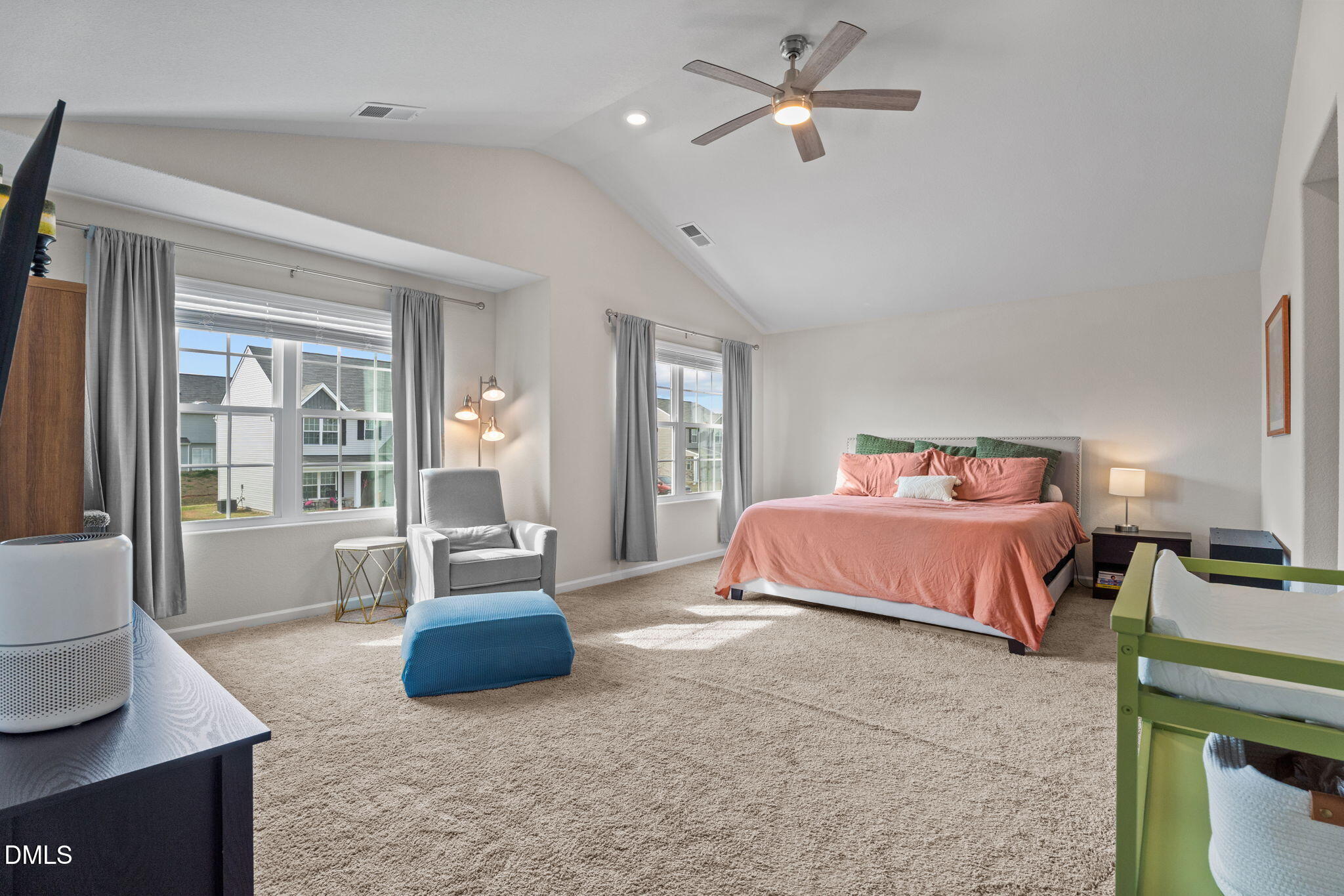 357 Gourd Street Zebulon, NC 27597 - Photo 25 of 50 a spacious bedroom with a bed a couch and large window
