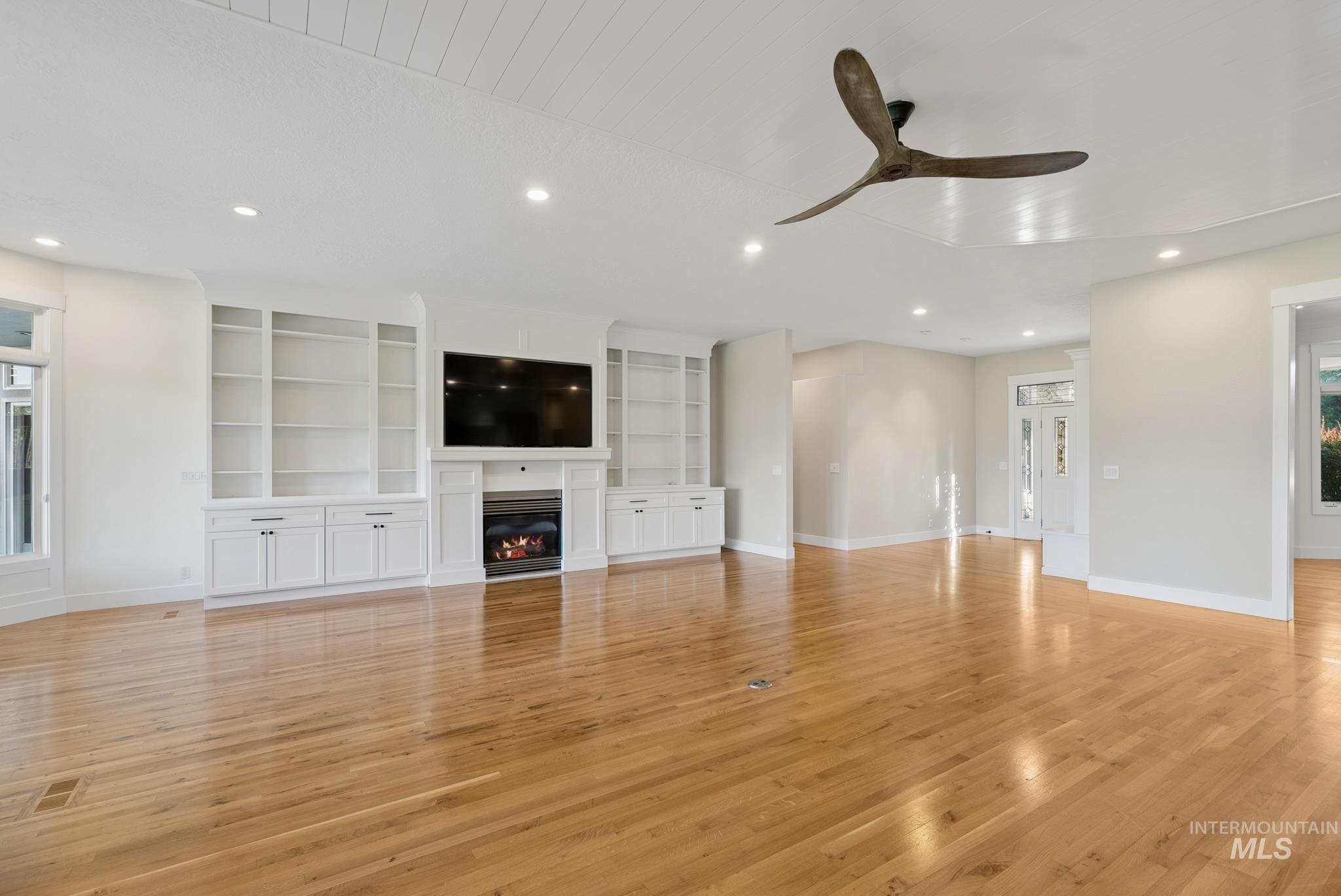 2050 Artesian Road Eagle, ID 83616 - Photo 8 of 49 Spacious living area featuring light wood-finish flooring, a white shiplap ceiling, and abundant natural light