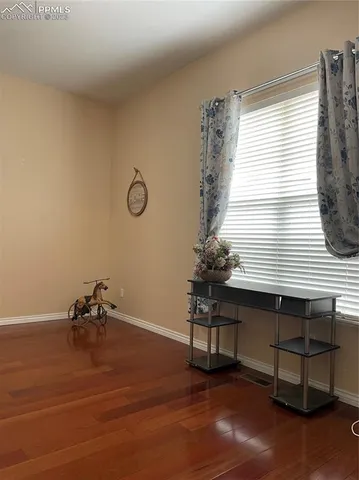 a room with a table chair and a window