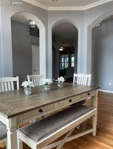 a view of living room with granite countertop furniture and wooden floor