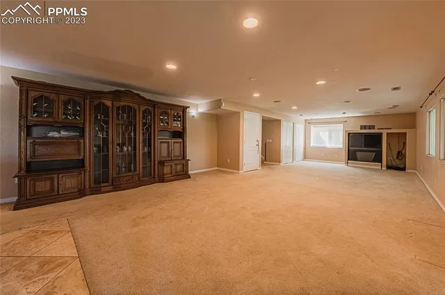 a view of an empty room with closet and bathroom