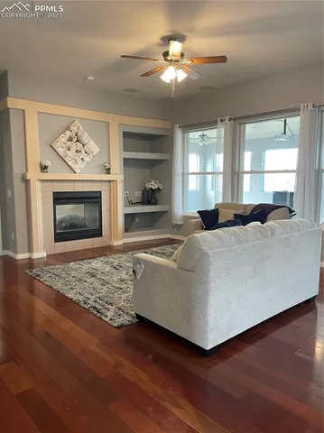 a living room with furniture fireplace and window