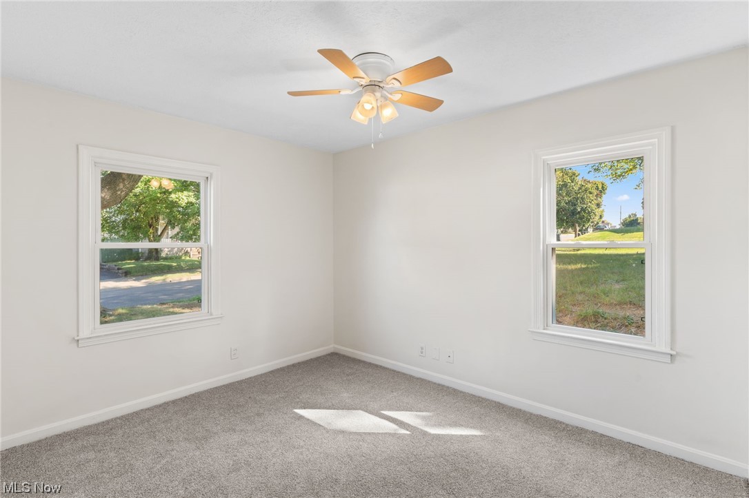 898 Reed Avenue Akron, OH 44306 - Photo 23 of 26 Carpeted empty room with a wealth of natural light and ceiling fan