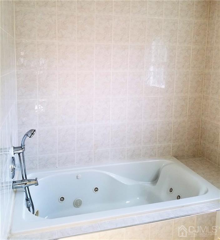 26 Baxter Road Edison, NJ 08817 - Photo 11 of 22 a bathroom with a tub and a shower