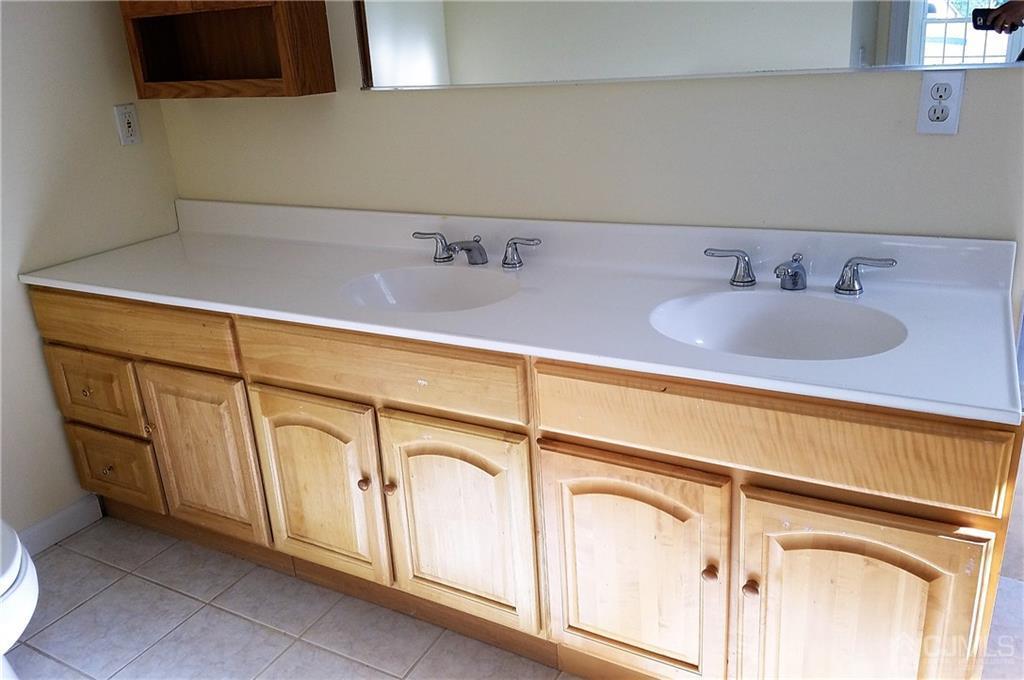 26 Baxter Road Edison, NJ 08817 - Photo 15 of 22 a bathroom with a sink and a washing machine