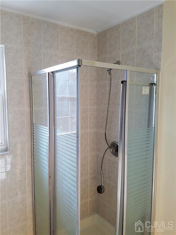 26 Baxter Road Edison, NJ 08817 - Photo 16 of 22 a bathroom with a shower and a glass door