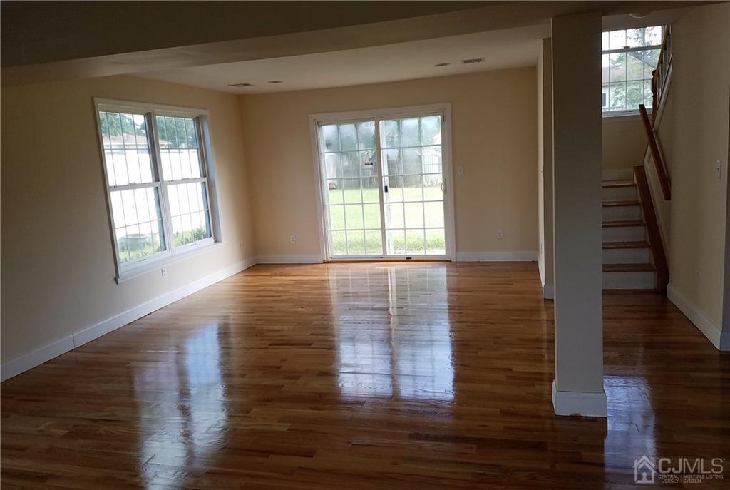 26 Baxter Road Edison, NJ 08817 - Photo 3 of 22 a view of empty room with wooden floor and fan