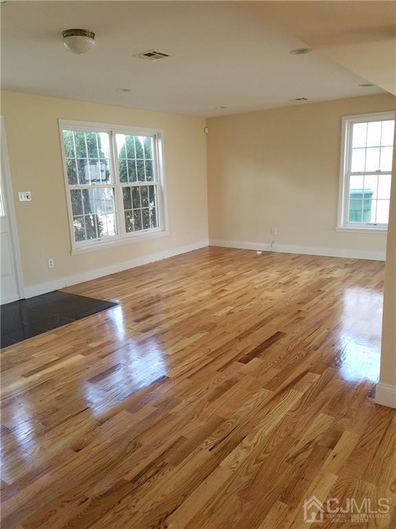 26 Baxter Road Edison, NJ 08817 - Photo 4 of 22 wooden floor in an empty room with a window