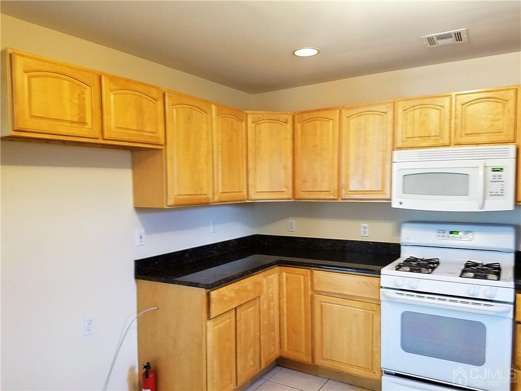 26 Baxter Road Edison, NJ 08817 - Photo 5 of 22 a kitchen with a stove and a refrigerator
