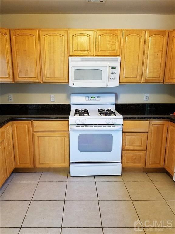 26 Baxter Road Edison, NJ 08817 - Photo 7 of 22 a kitchen with a stove a sink and a refrigerator