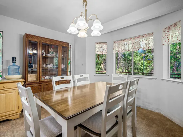 a large kitchen with stainless steel appliances granite countertop lots of counter top space and wooden floor