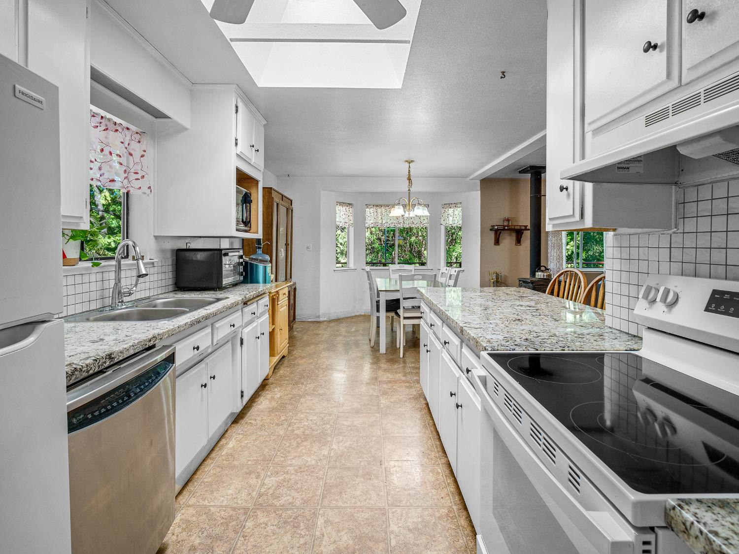 18960 Quailrun Fiddletown, CA 95629 - Photo 22 of 32 a large kitchen with stainless steel appliances granite countertop lots of counter top space and wooden floor
